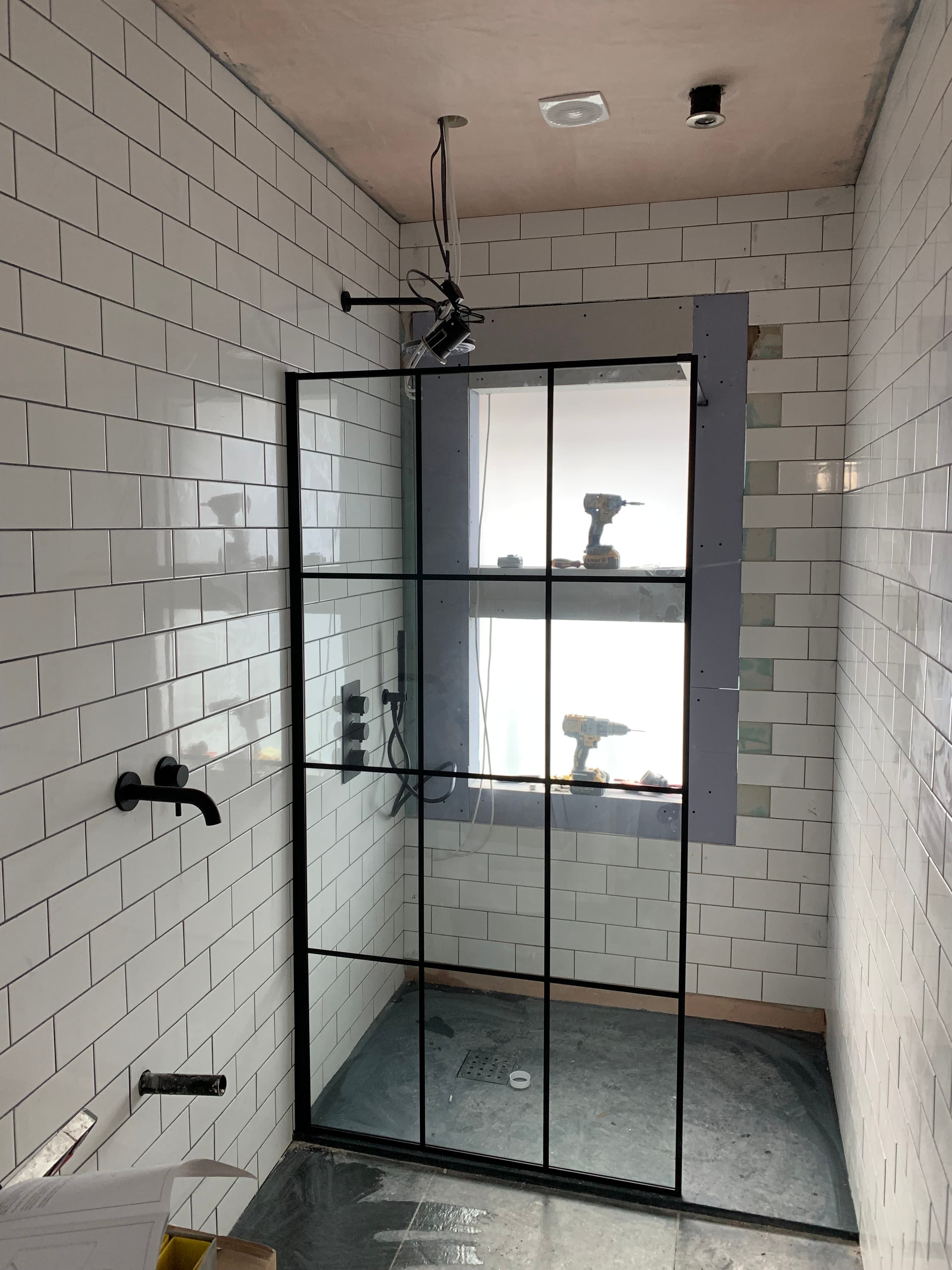 Black frame shower detail in a completed bathroom